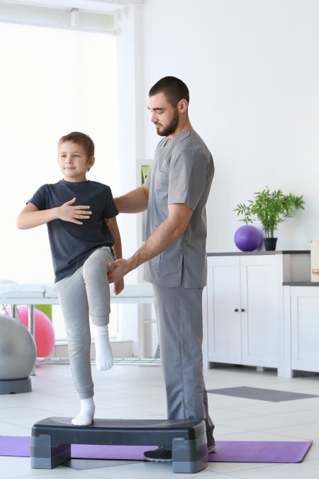 Physiotherapist working with patient in clinic